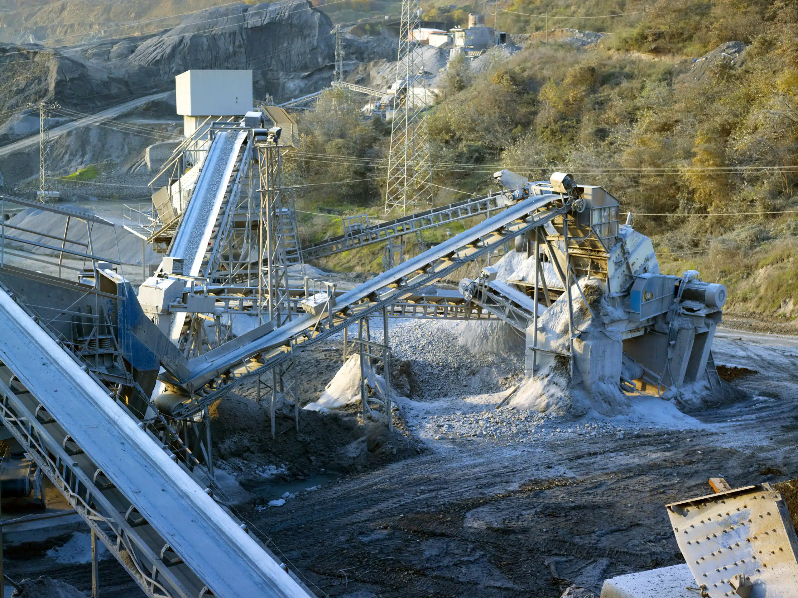 Stone quarry with silos, conveyor belts, and piles of stones